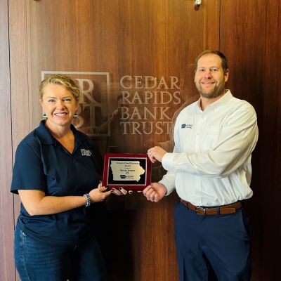Teresa Jensen Receiving “Friend of Small Business Award” plaque from Iowa Business Growth